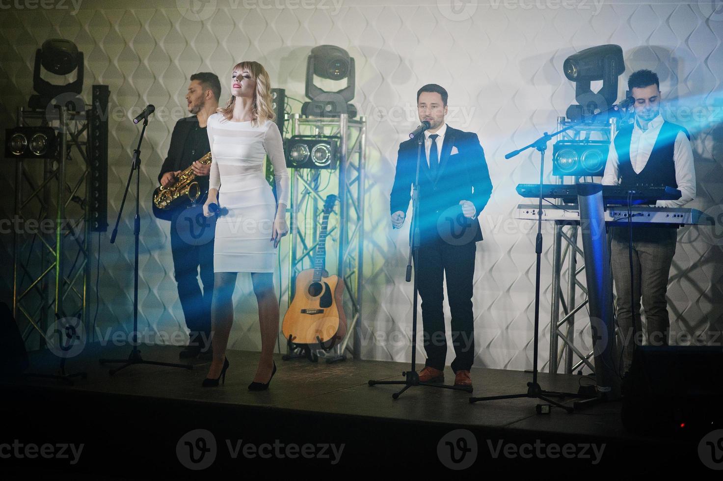 Musicial music live band performing on a stage with different lights. photo