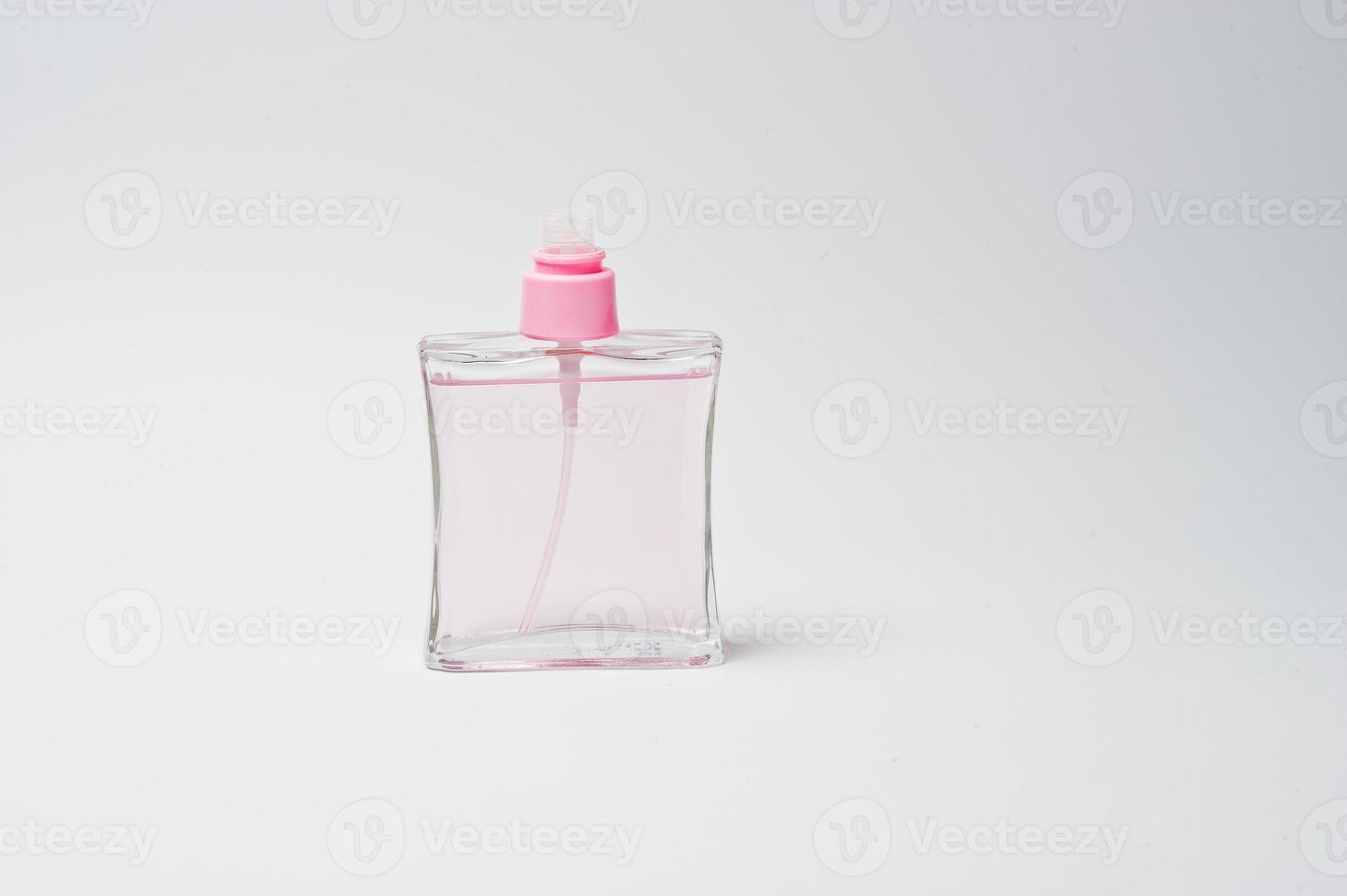 Close-up photo of pink perfumes on white background.