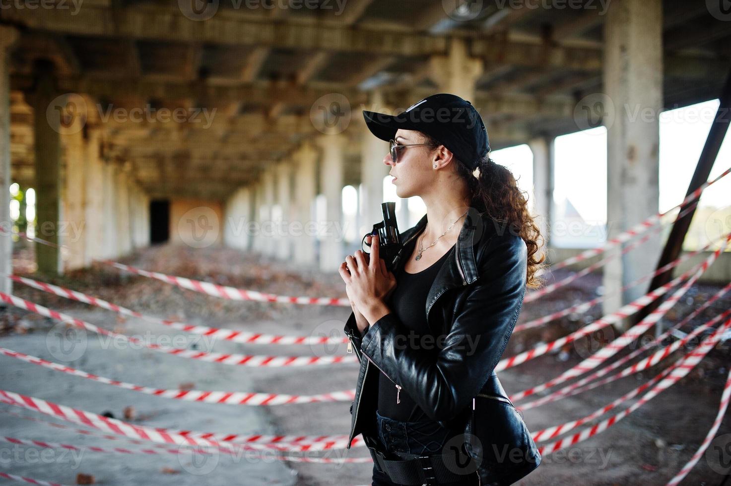 Sexy FBI female agent at abadoned place. photo