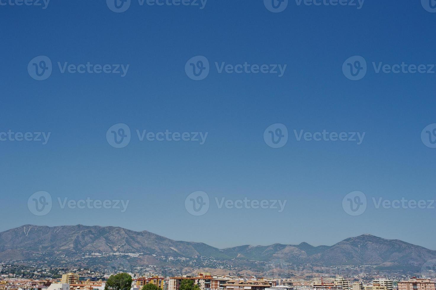 Breathtaking view at the small mediterranean town next to the mountain range. photo