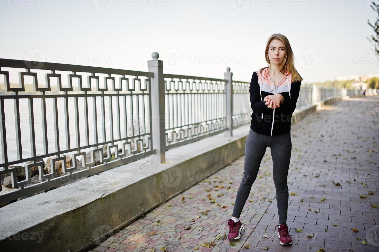 Young girl has the training and doing exercise outdoors. Sport, fitness, street workout concept. photo