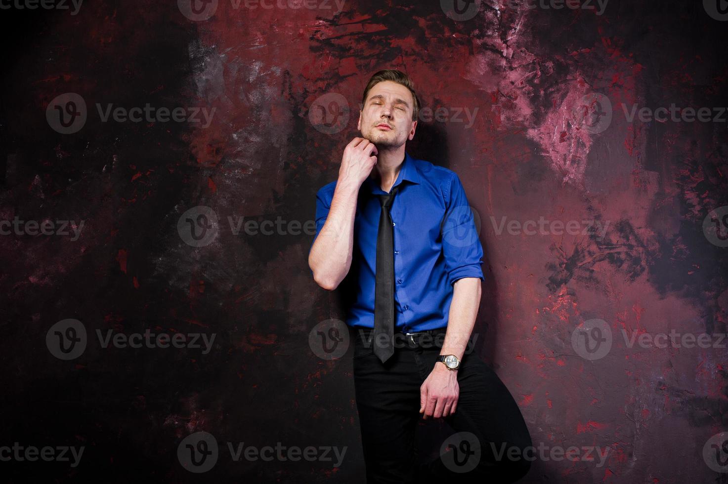 Studio portrait of stylish man, wear on blue shirt and necktie. photo