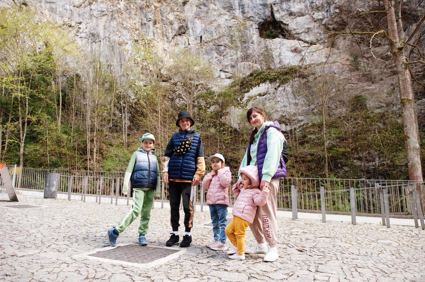 Family explores at Punkva Caves outdoor near rocks, Czech Republic. photo