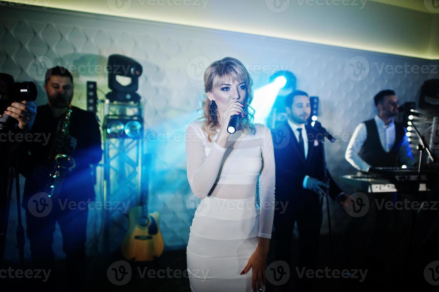 Musicial music live band performing on a stage with different lights. photo