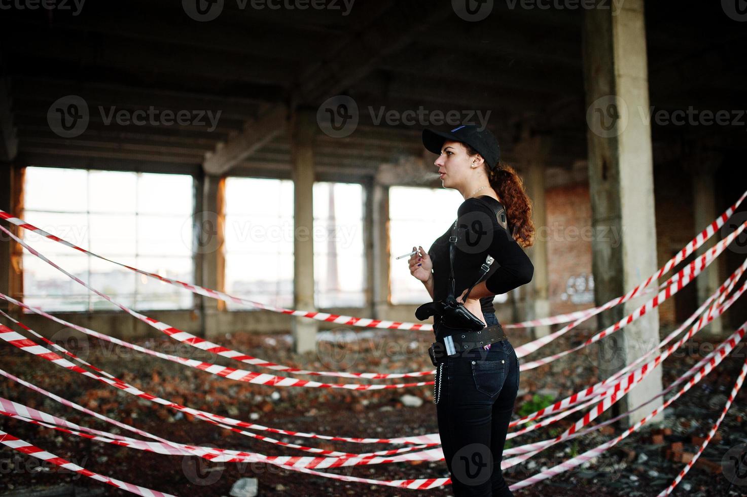 Sexy FBI female agent at abadoned place. photo