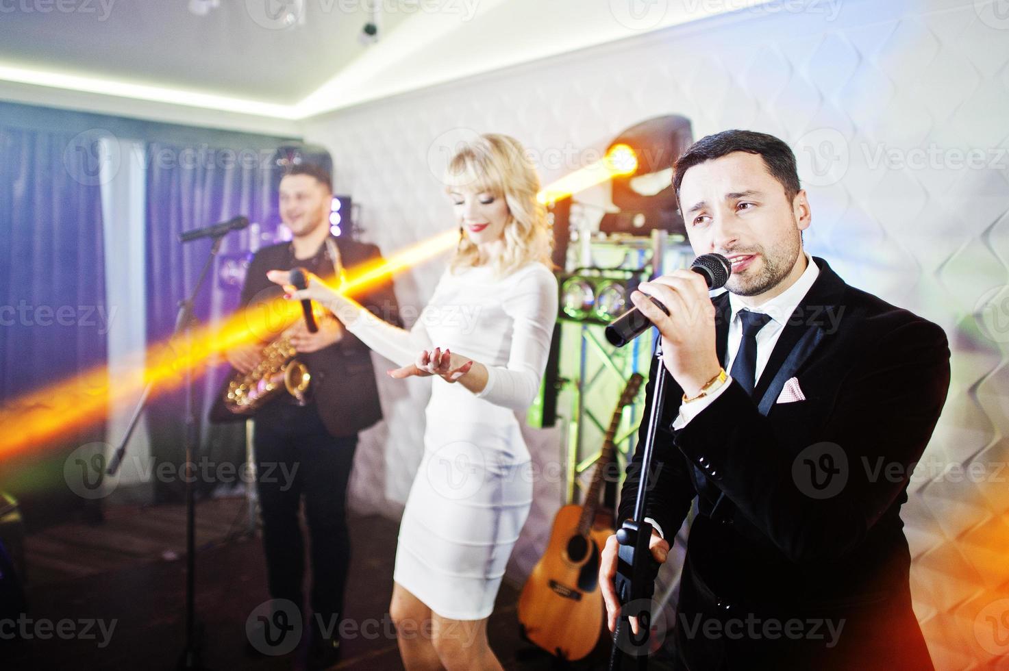 Musicial music live band performing on a stage with different lights. photo