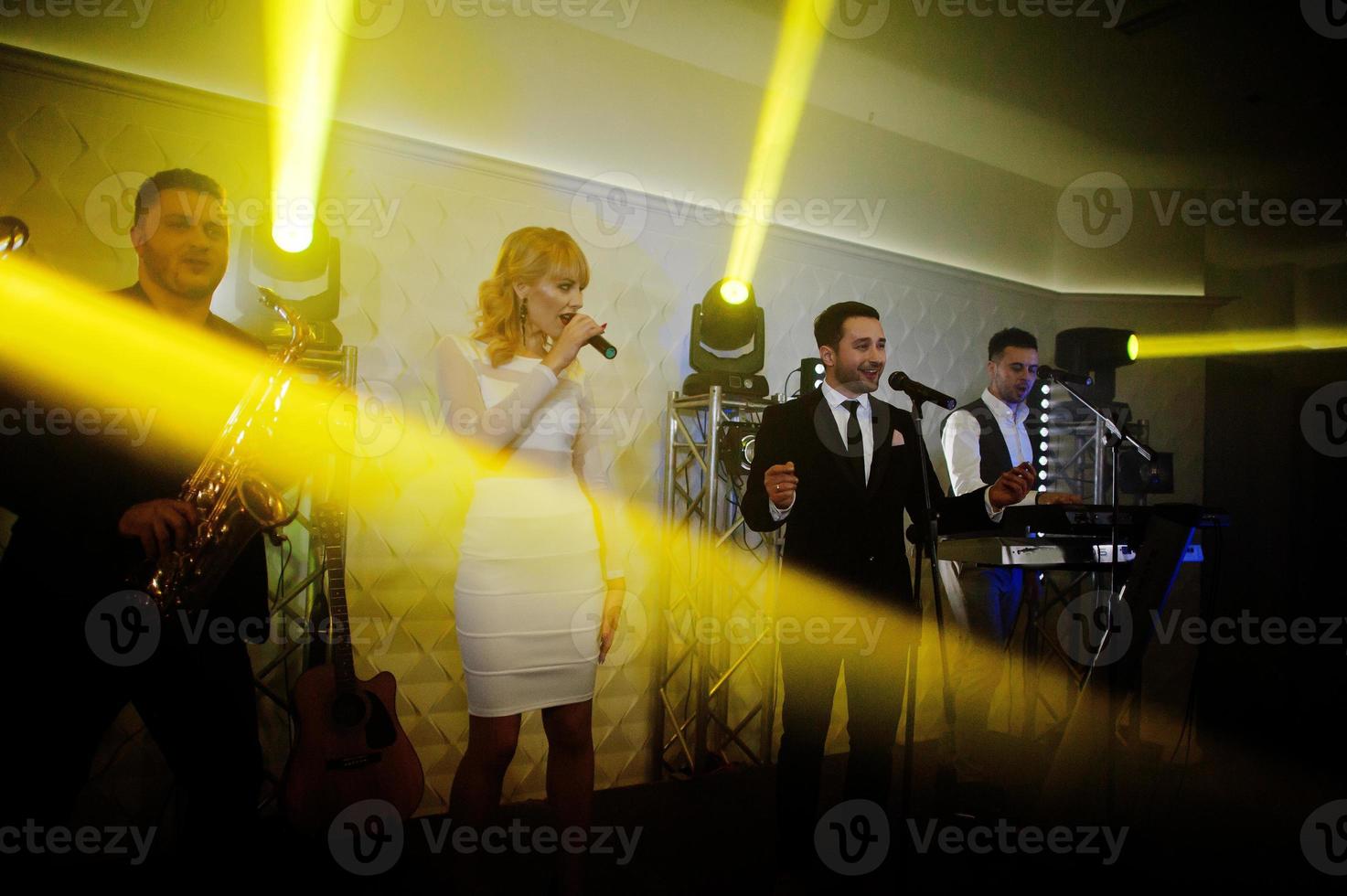 Musicial music live band performing on a stage with different lights. photo