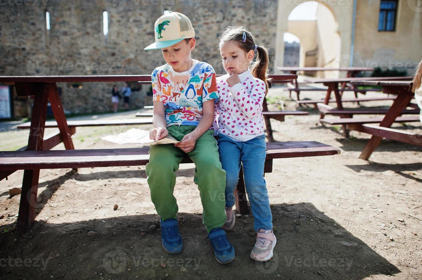 Brother with sister on a tour looking at map of Veveri castle, Czech Republic. photo