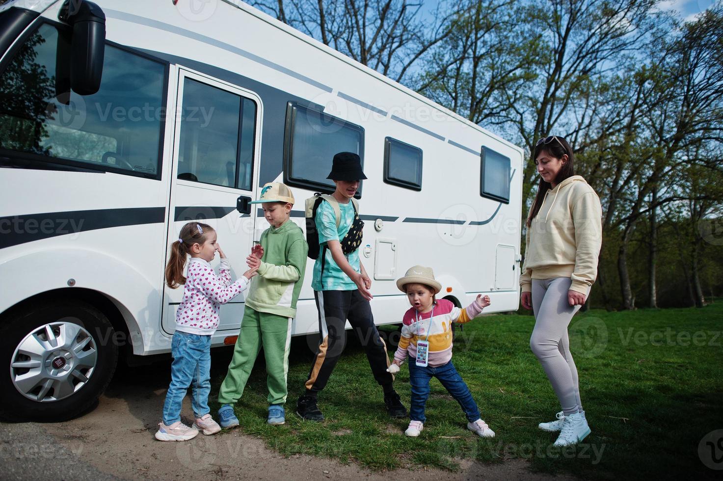 Mother with four children travel at motorhome RV camper van. photo