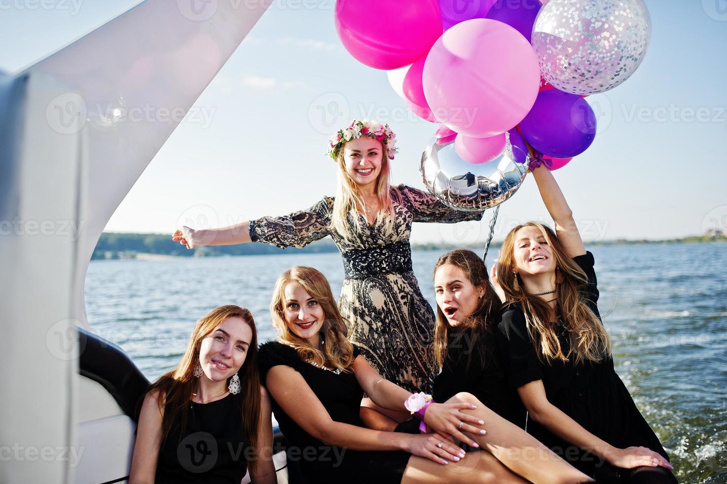 Girls having fun at yacht on hen party. photo