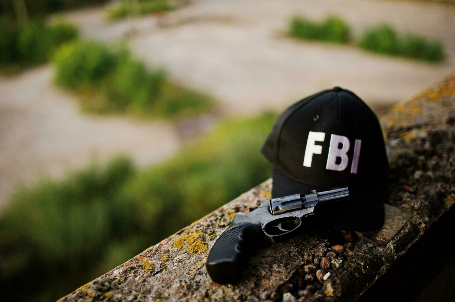 FBI cap with revolver and handcuff. photo