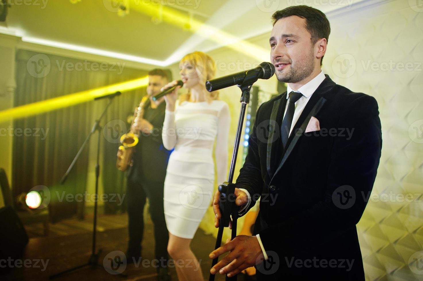 Musicial music live band performing on a stage with different lights. photo