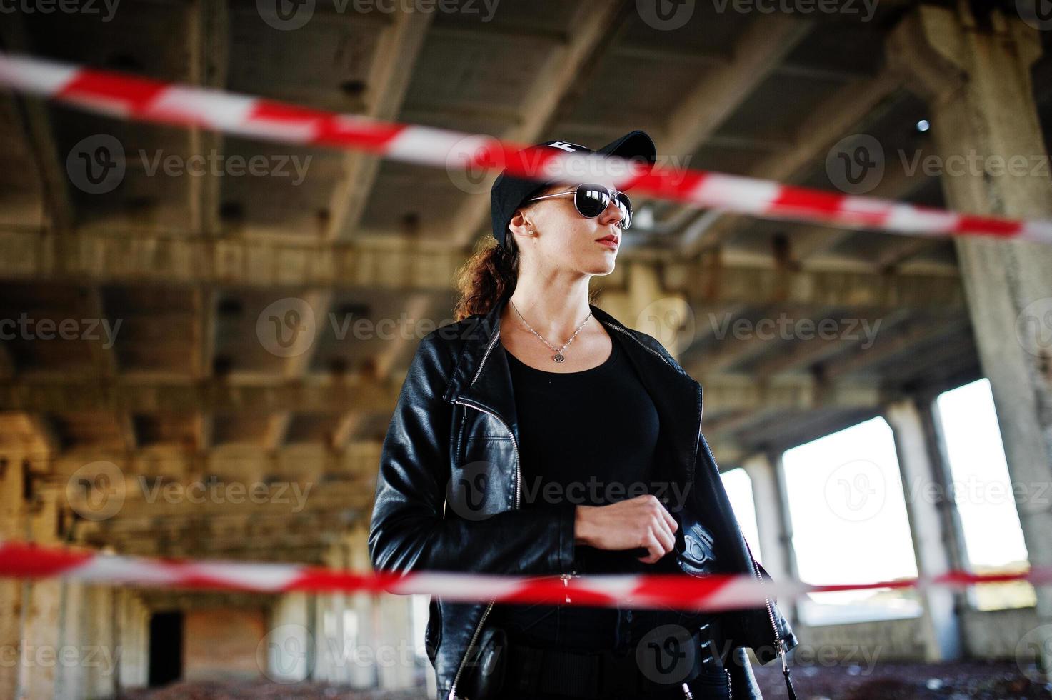 Sexy FBI female agent at abadoned place. photo