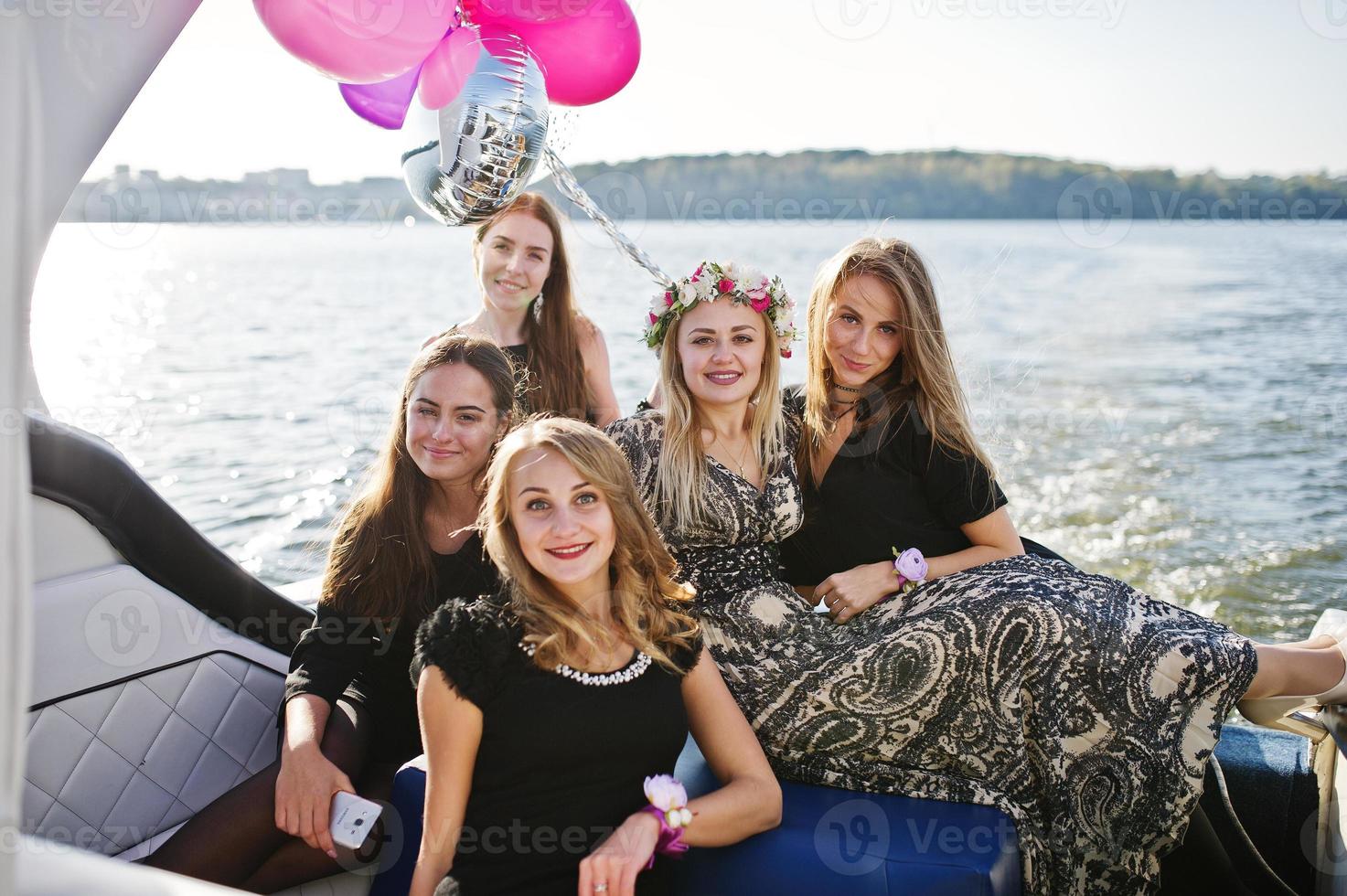 Girls having fun at yacht on hen party. photo