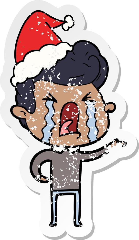 distressed sticker cartoon of a crying man wearing santa hat vector