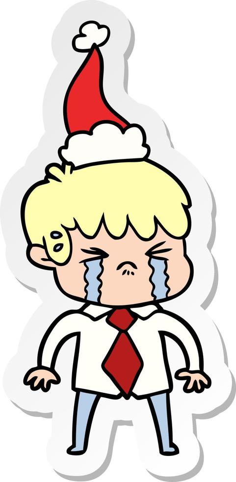 sticker cartoon of a boy crying wearing santa hat vector