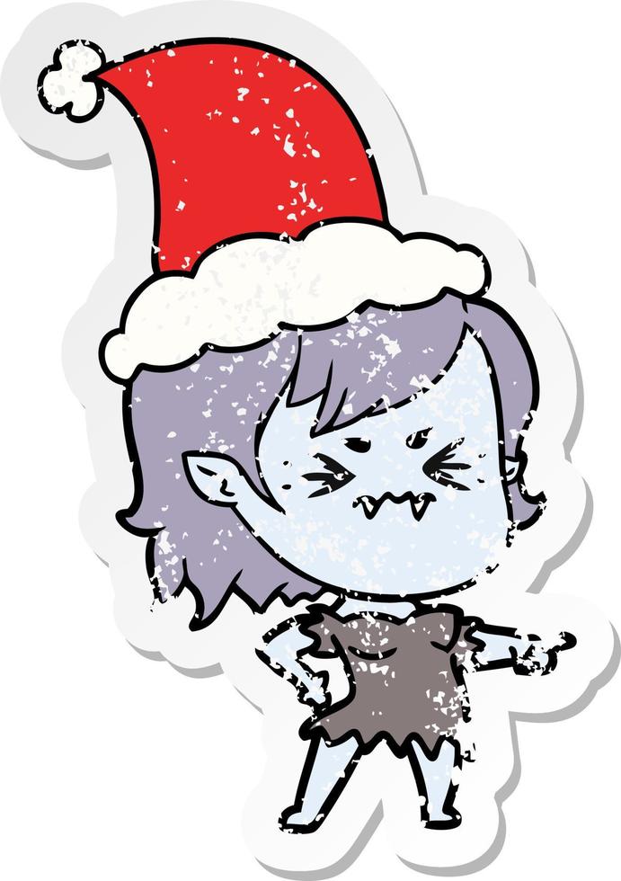 annoyed distressed sticker cartoon of a vampire girl wearing santa hat vector