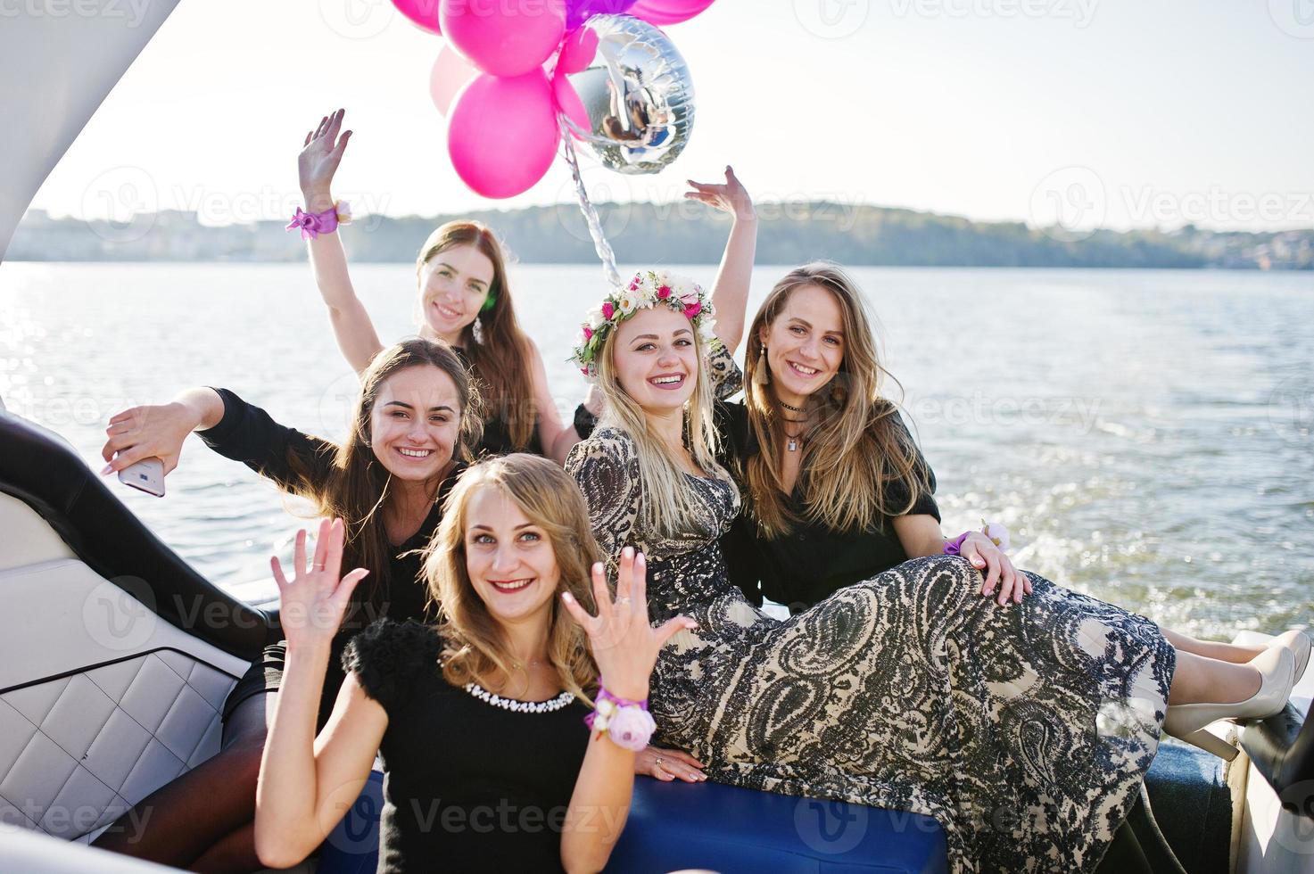 Girls having fun at yacht on hen party. photo