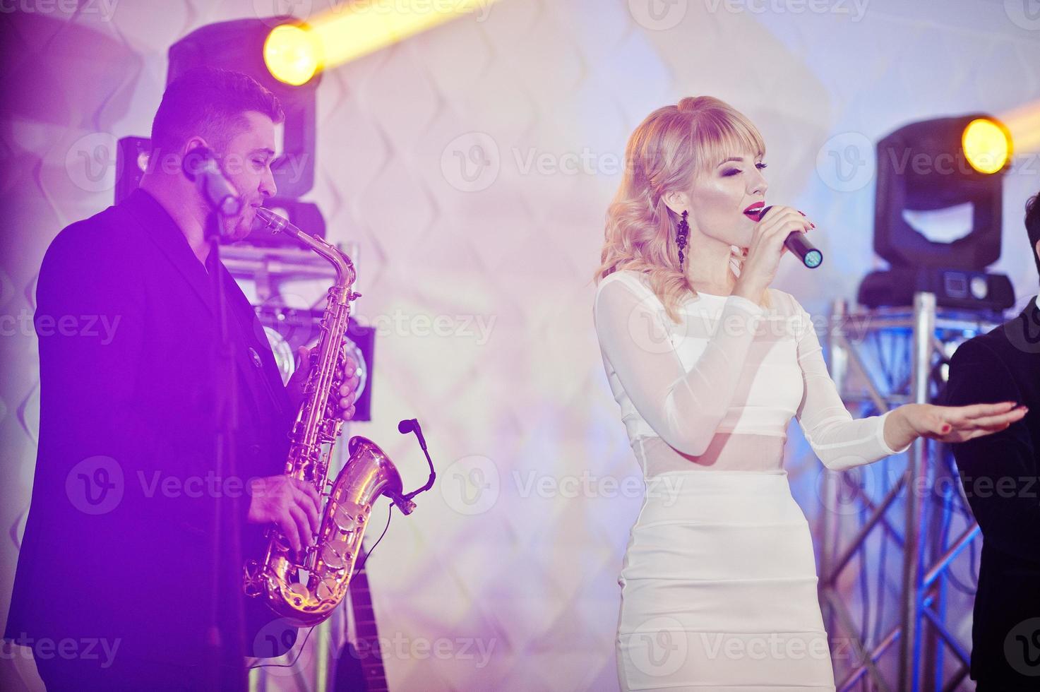 Musicial music live band performing on a stage with different lights. photo