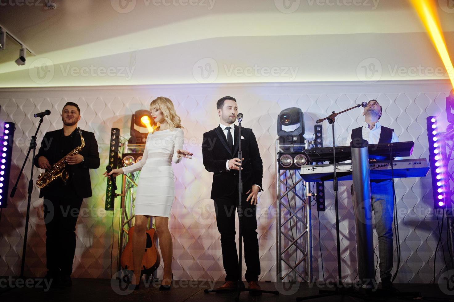 Musicial music live band performing on a stage with different lights. photo