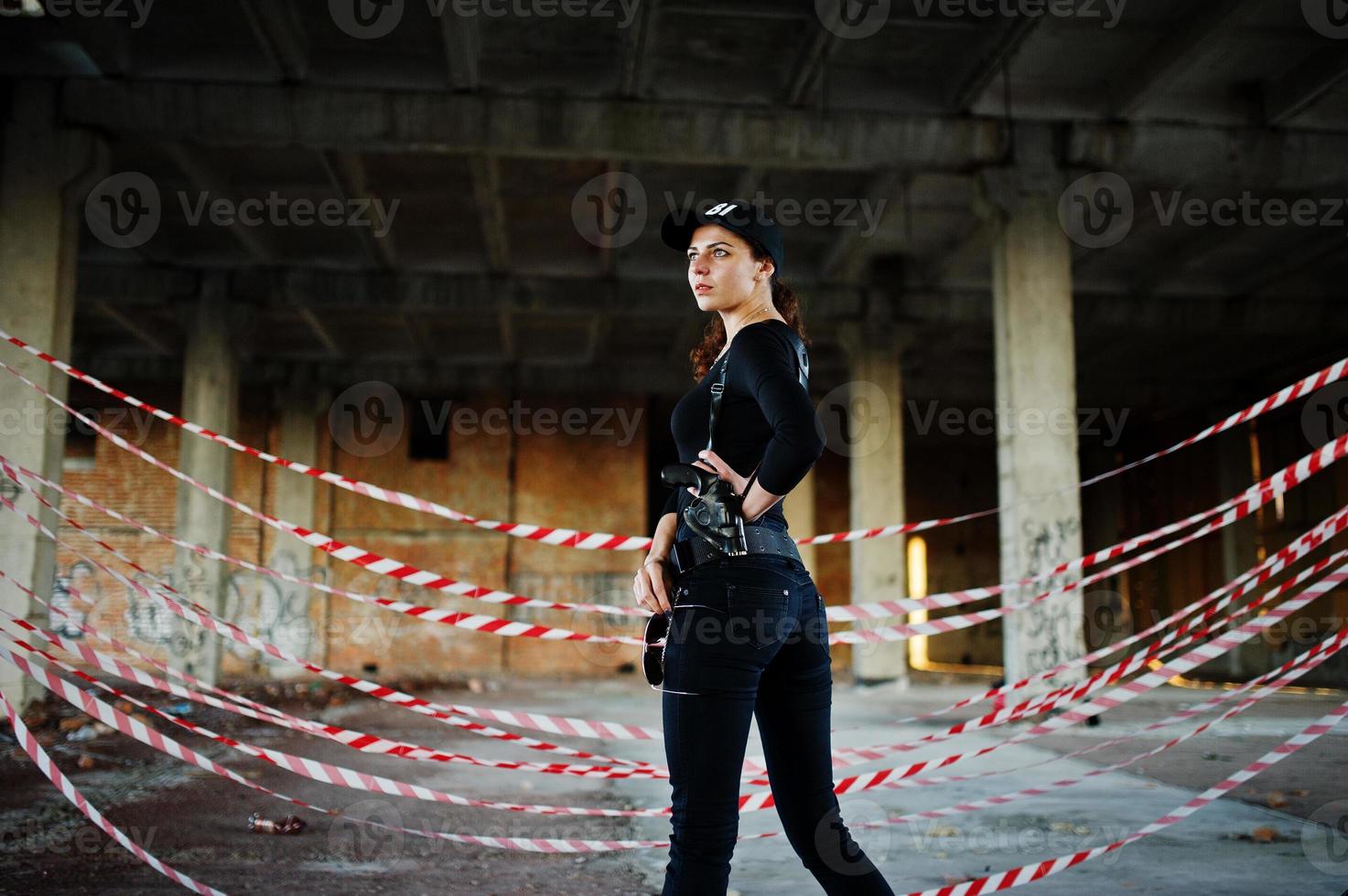 Sexy FBI female agent at abadoned place. photo