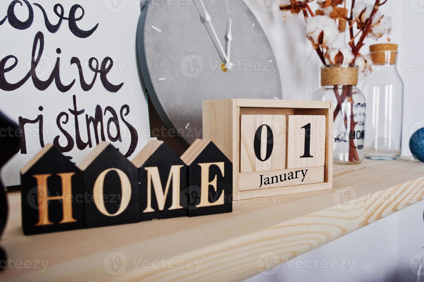 1 January wooden calendar with home sign. Happy winter holidays concept. photo