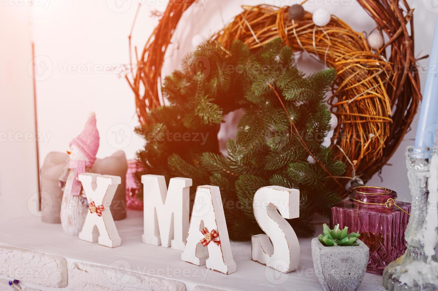 X-Mas word decor with wreath. Happy winter holidays concept. photo