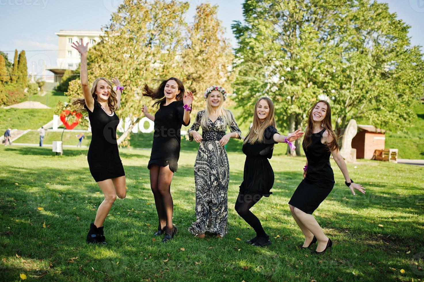 Five girls wear on black jumping at hen party. photo