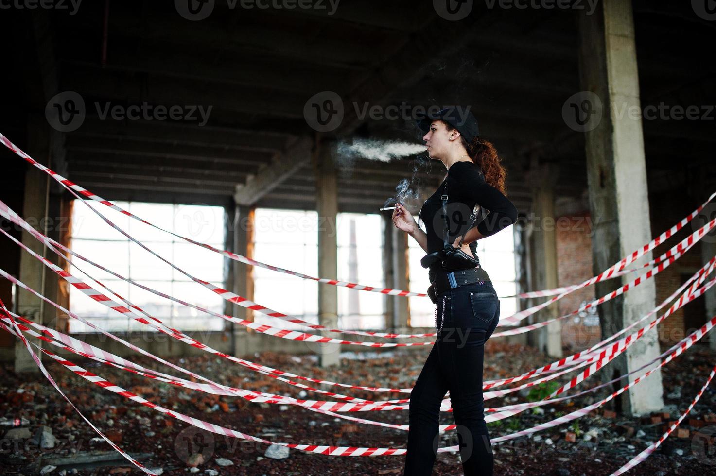 Sexy FBI female agent at abadoned place. photo