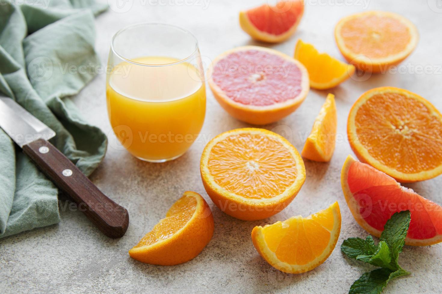 Glasses of juice and citrus fruits photo