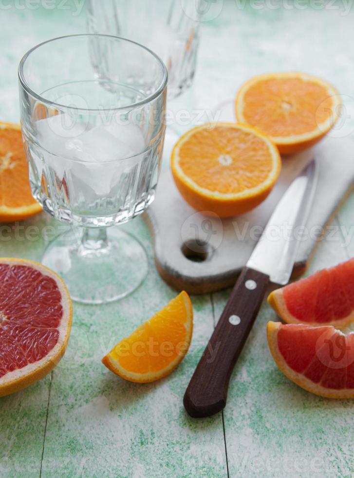 Glass of juice and citrus fruits photo