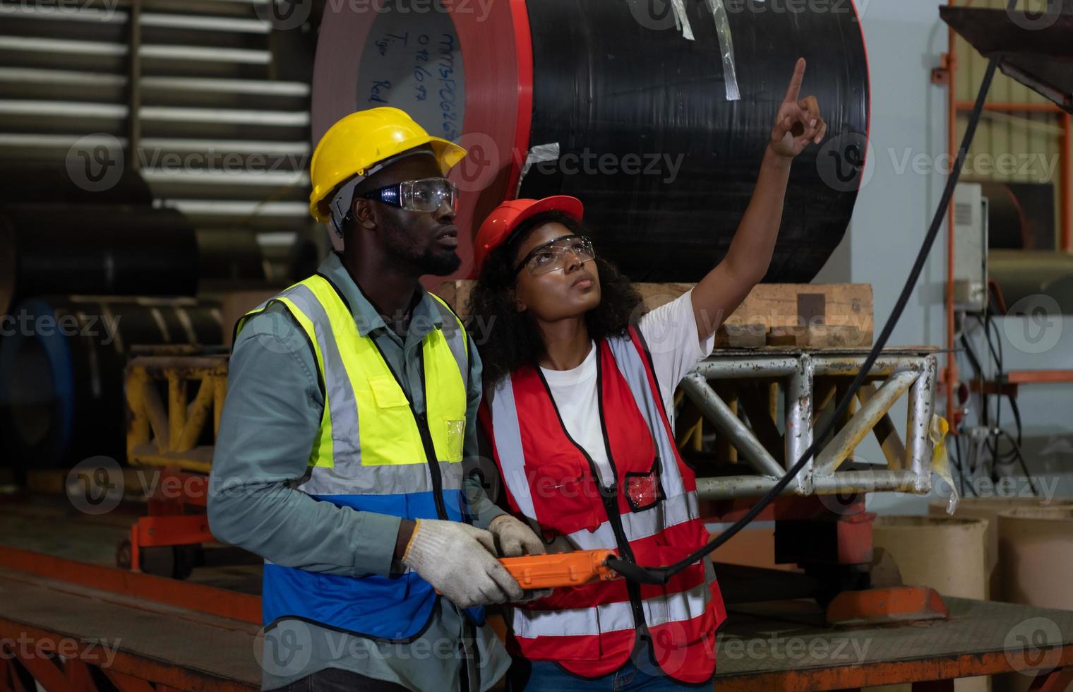 Two technicians Inspecting and testing the operation of lifting cranes in heavy industrial plants. photo