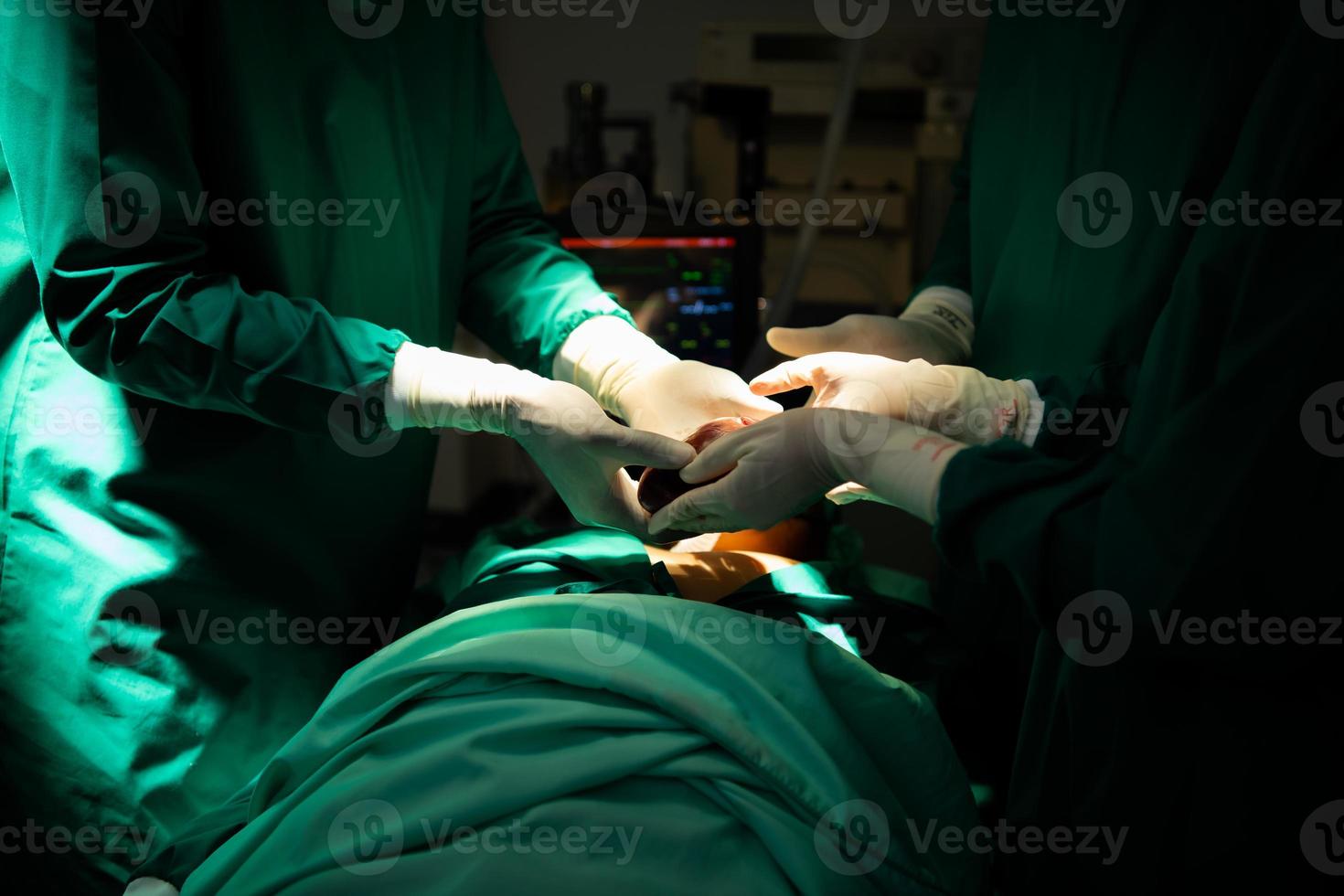 The doctor in operating room undergoing surgery to replace a patient's heart photo