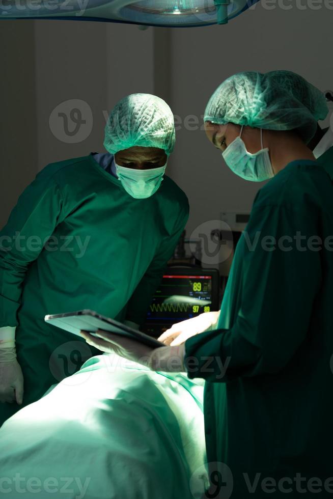 The doctor is discussing the case with a tablet. photo