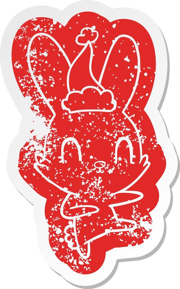 cute cartoon distressed sticker of a rabbit dancing wearing santa hat vector