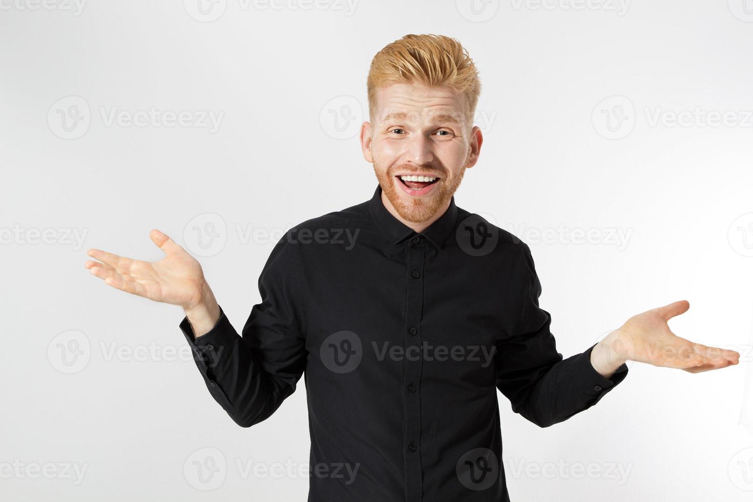 Red-head man dont know or not sure. Skeptic, unsure, uncertain, doubts concept. Young white guy in black wear is looking sceptical, handsome young female on the white background showing attitude photo