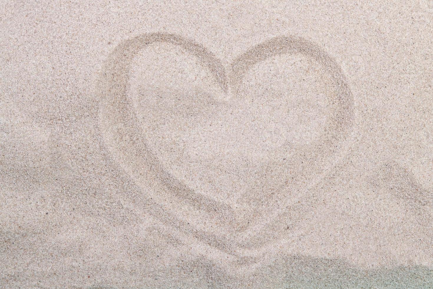 Sea coast. Inscription heart on beach sand photo