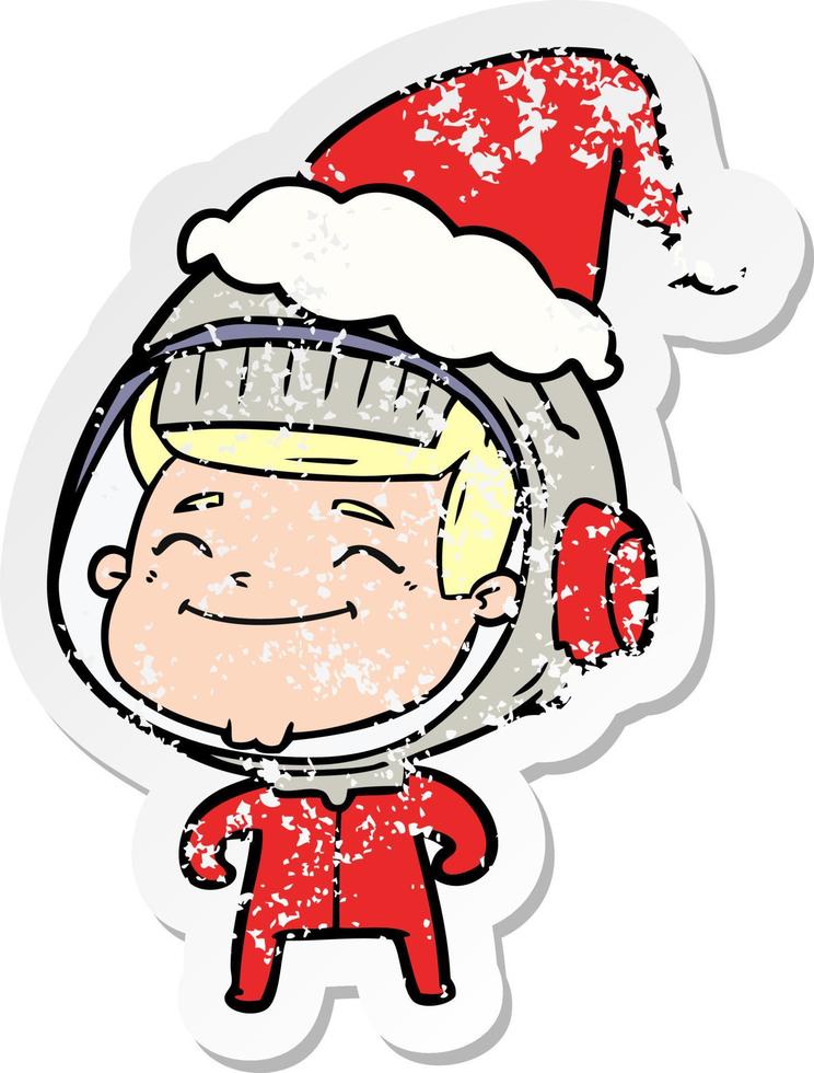 happy distressed sticker cartoon of a astronaut wearing santa hat vector