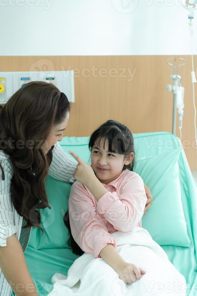 A mother who cares for her beloved child who treats pediatric diseases. in order to keep your child in a good mood before the surgery in operation room photo