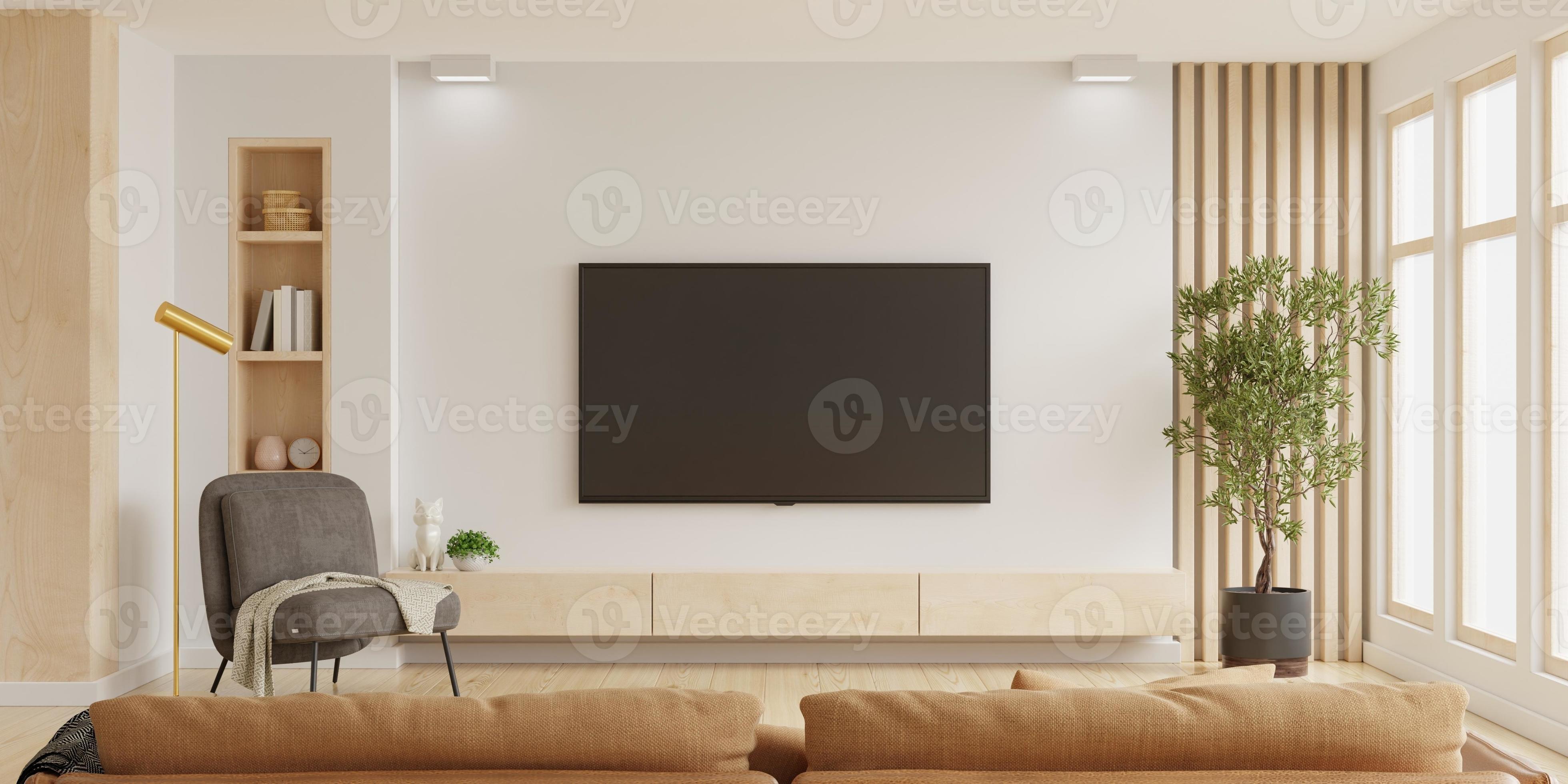 White wall mounted tv on in living room with dark brown