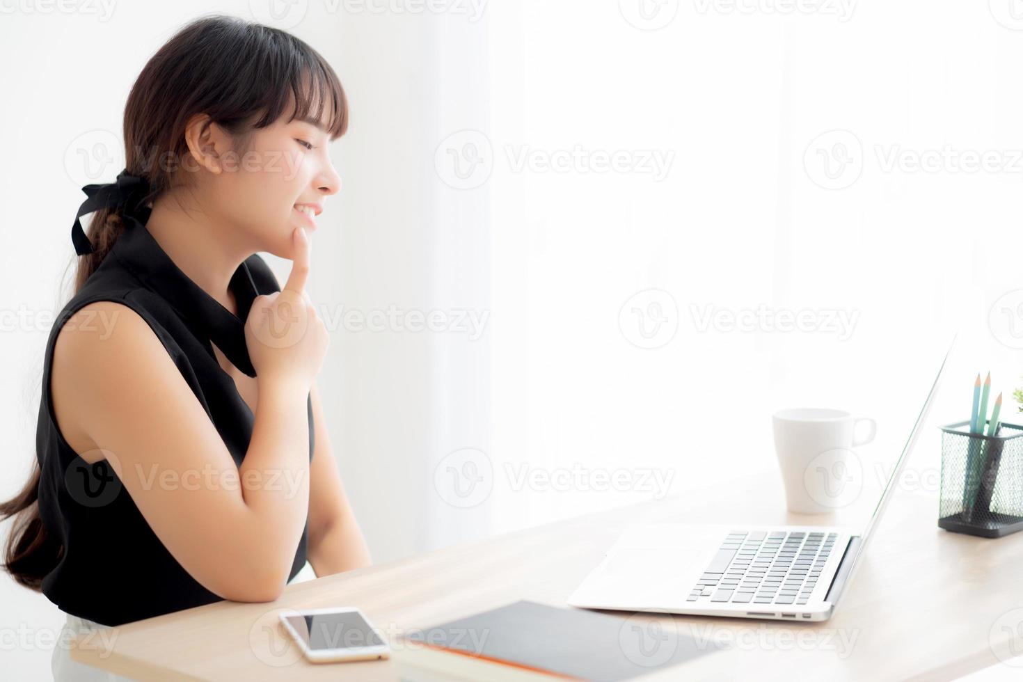 Beautiful freelance young asian woman thinking and idea working laptop computer at office, writer asia girl thoughtful inspiration writing blogging with notebook in job, business concept. photo