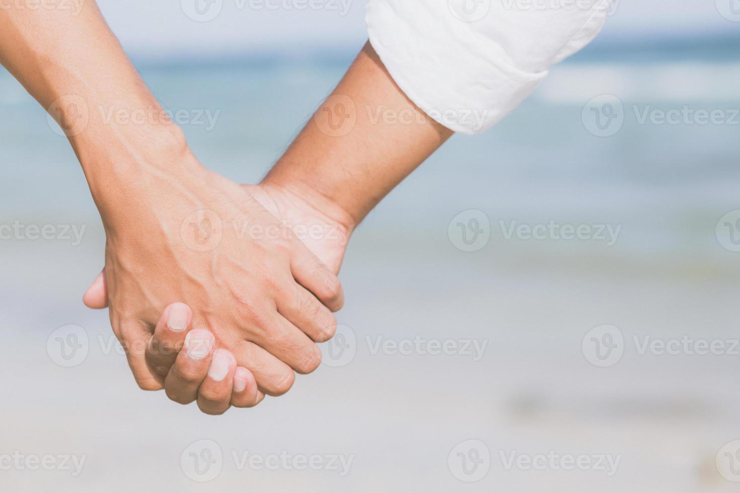 Closeup asian gay couple holding hands together on the beach with relax and leisure in summer, LGBT homosexual legal two man happy and romantic in vacation, relationship sex lover concept. photo