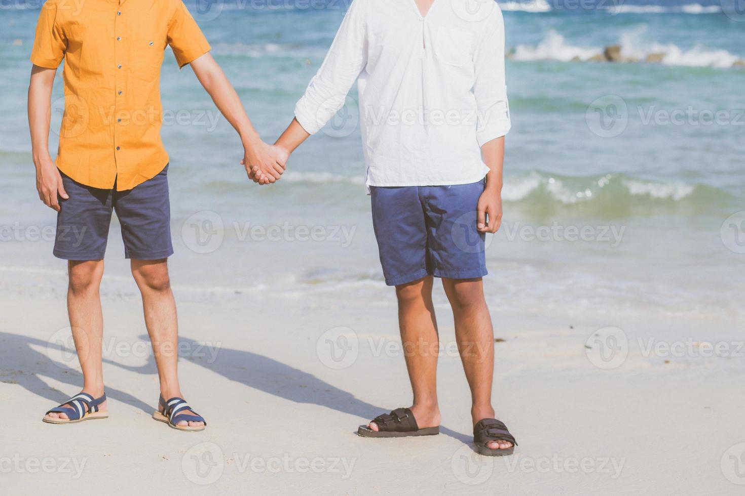 Closeup asian gay couple holding hands together on the beach with relax and leisure in summer, LGBT homosexual legal two man happy and romantic in vacation, relationship sex lover concept. photo