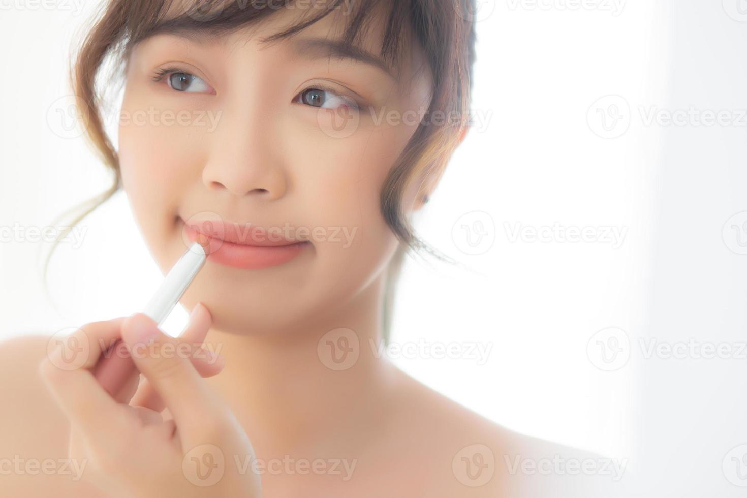 Beautiful portrait young asian woman looking mirror applying makeup lipstick at room, beauty lips asia girl makeup and cosmetic fashion on mouth at home, lifestyle and health care concept. photo