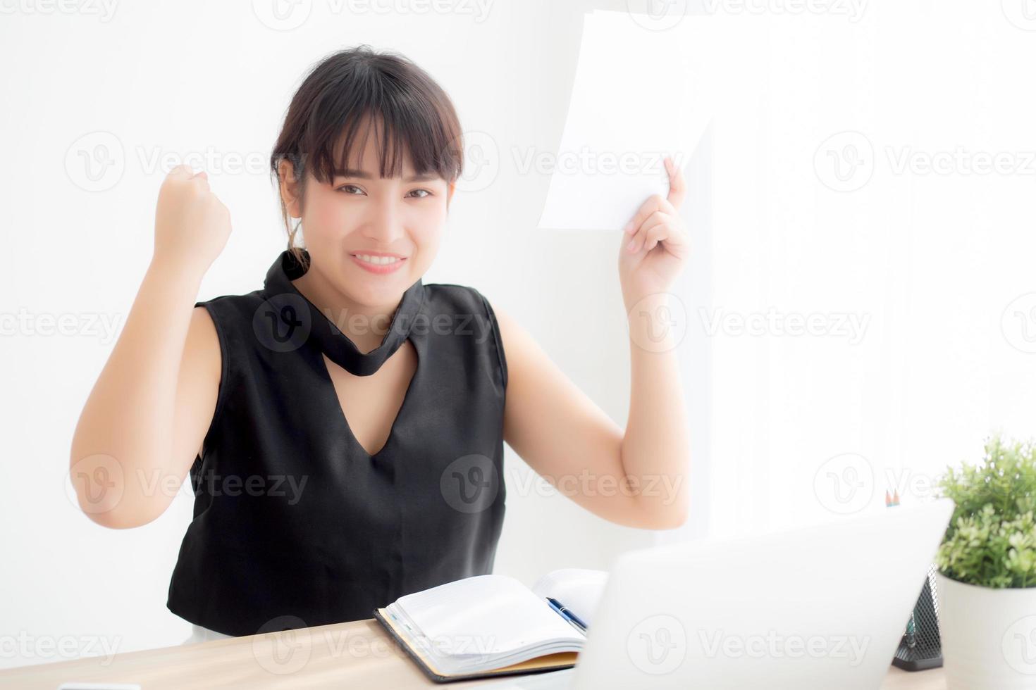 Beautiful young asian woman working laptop computer at office, businesswoman looking graph diagram analysis statistic data with excited and success, girl using notebook, business concept. photo