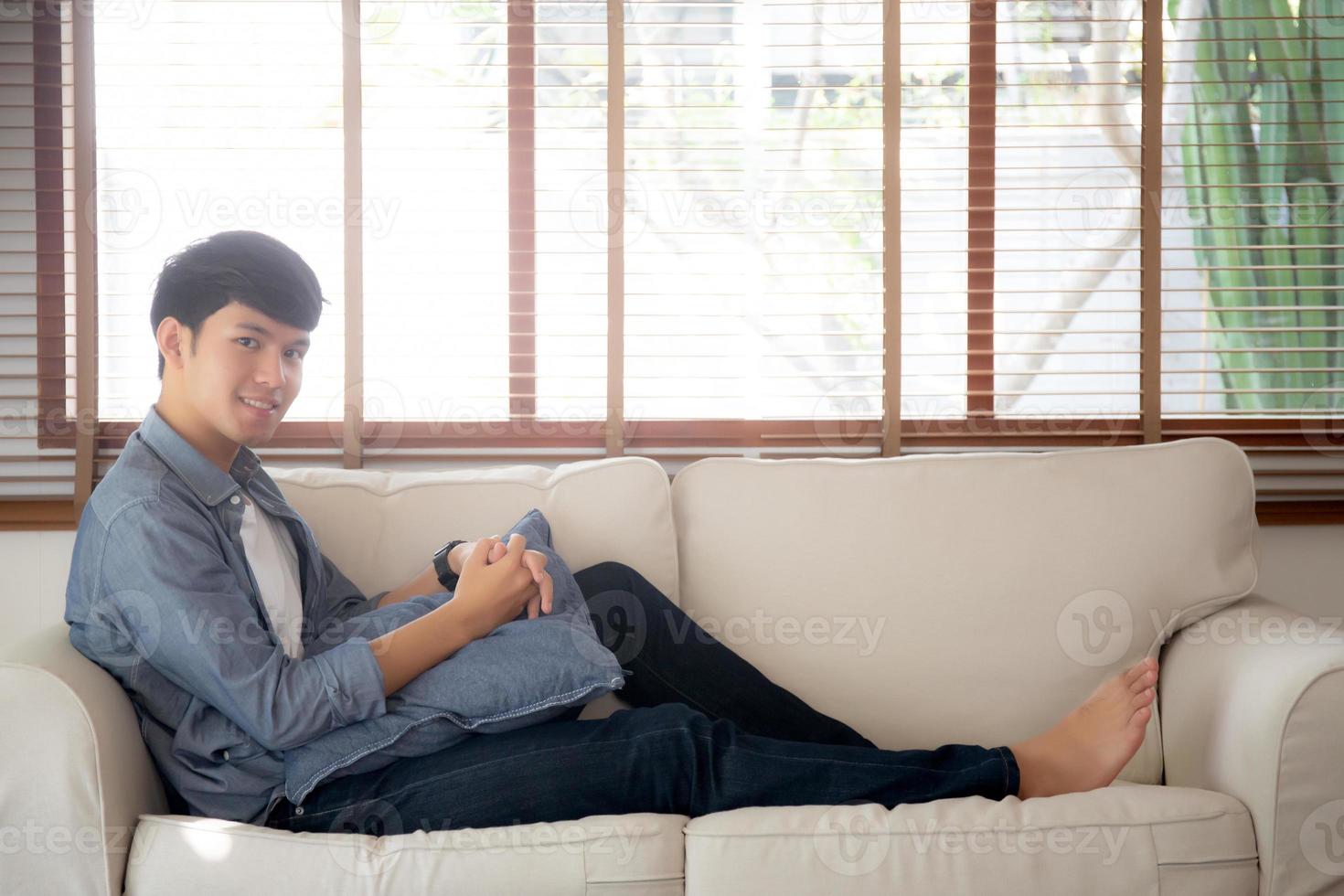 retrato joven apuesto hombre asiático tomando una siesta relajarse con acogedor en el sofá en casa, hombre de asia descansando y durmiendo el fin de semana con cansado y perezoso en el sofá en concepto de vacaciones, estilo de vida y bienestar. foto