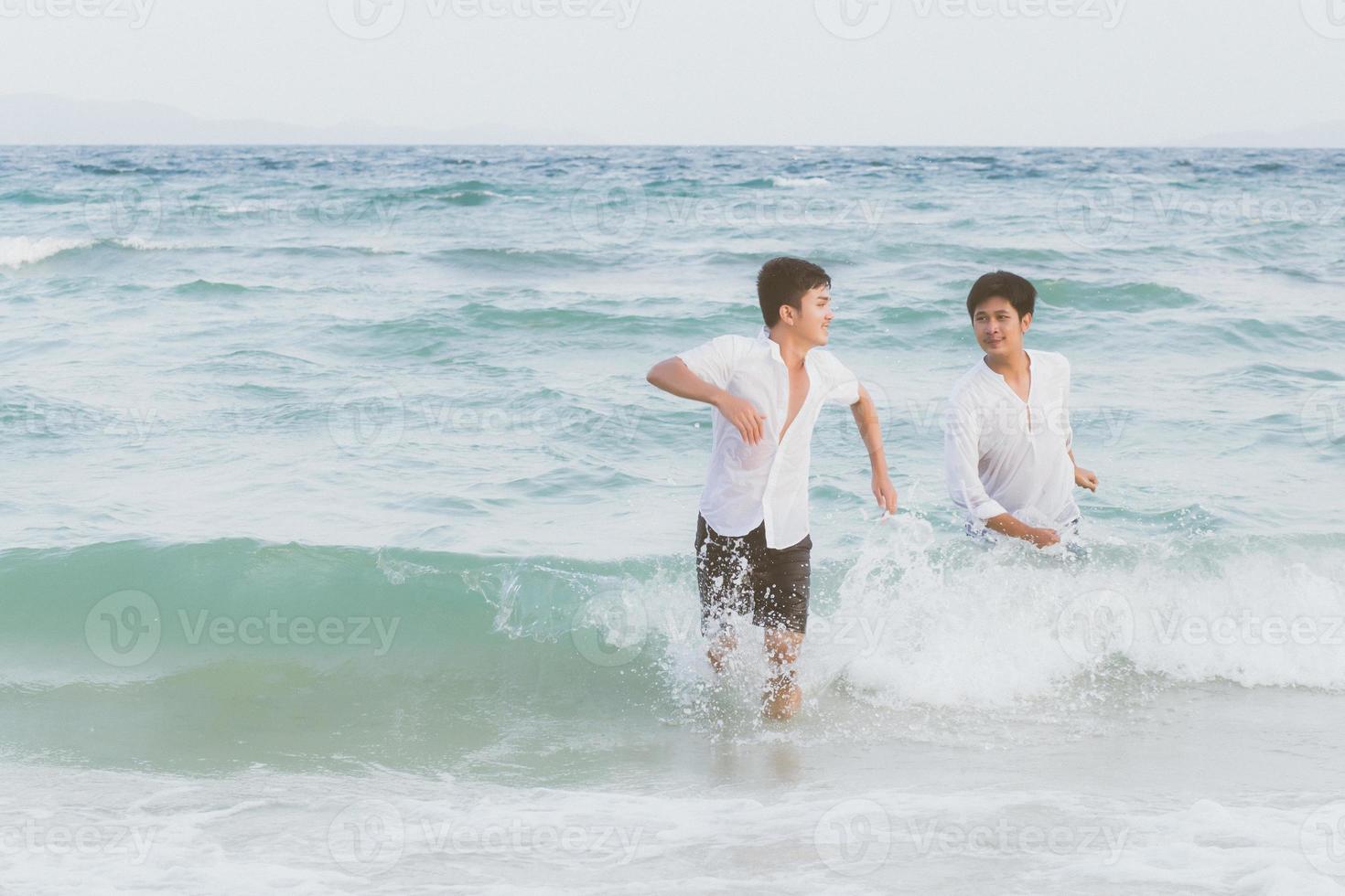 Homosexual portrait young asian couple running with cheerful together on beach in summer, asia gay going tourism for leisure and relax with happiness in vacation at sea, LGBT legal concept. photo