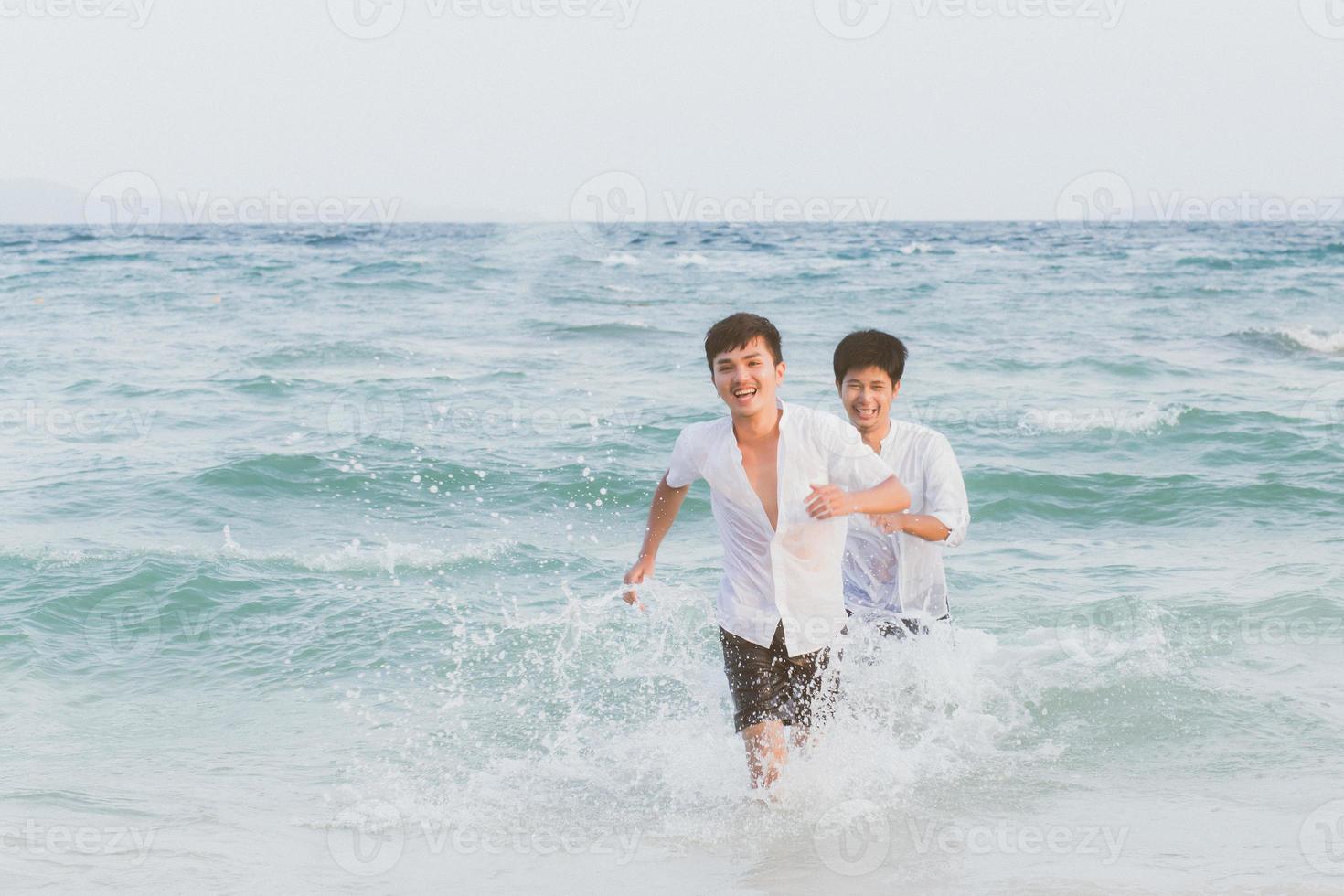 Homosexual portrait young asian couple running with cheerful together on beach in summer, asia gay going tourism for leisure and relax with happiness in vacation at sea, LGBT legal concept. photo