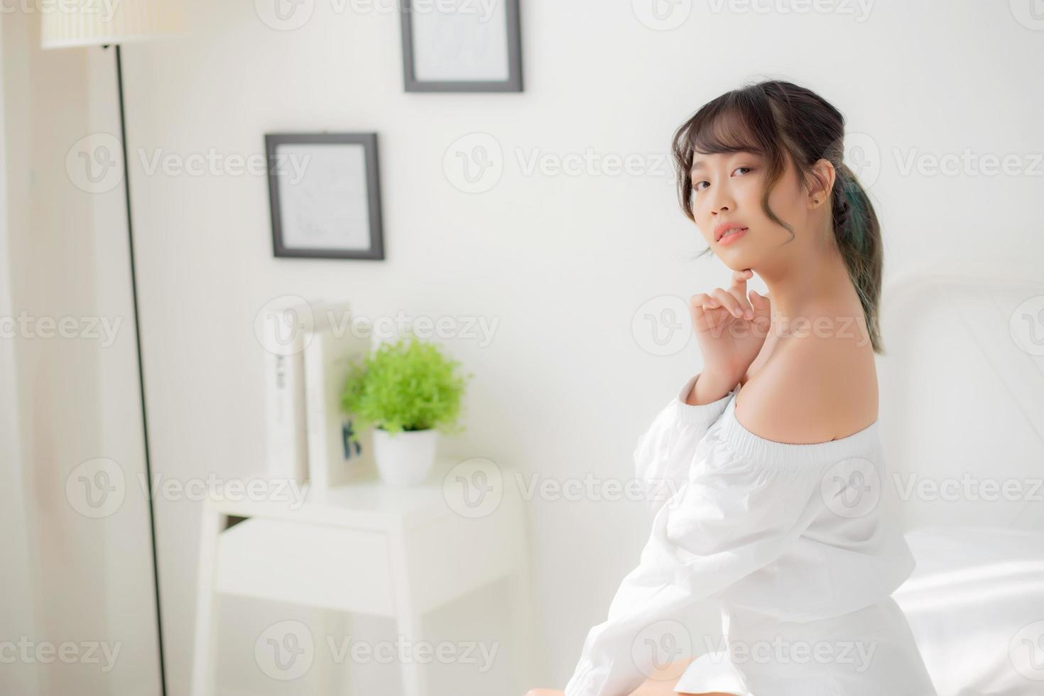 Portrait of beautiful young asian woman makeup of cosmetic, girl happy and smile attractive, face of beauty perfect with wellness in the bedroom at home with skin care and healthcare concept. photo
