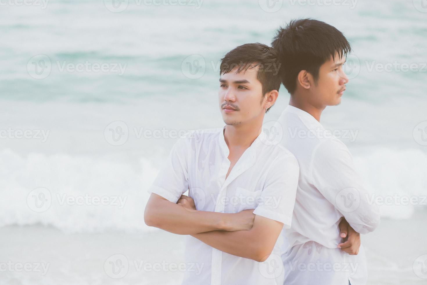 Homosexual portrait young asian couple standing problem on beach in summer, asia gay angry and unhappy in vacation at sea, relationship with disappointed and frustrated, LGBT with legal concept. photo